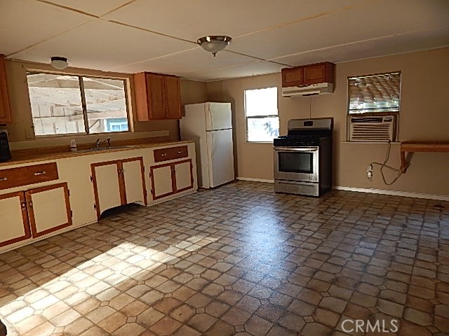 818 South Tehama Street Willows, CA 95988 - Photo 5 of 12 a kitchen with stainless steel appliances a stove a sink and a refrigerator