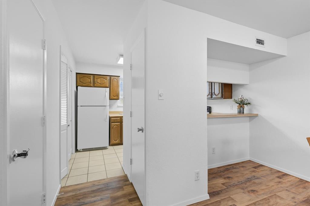 910 Turtle Cove, Unit 148 Irving, TX 75060 - Photo 13 of 33 a view of a hallway with wooden floor and a bathroom