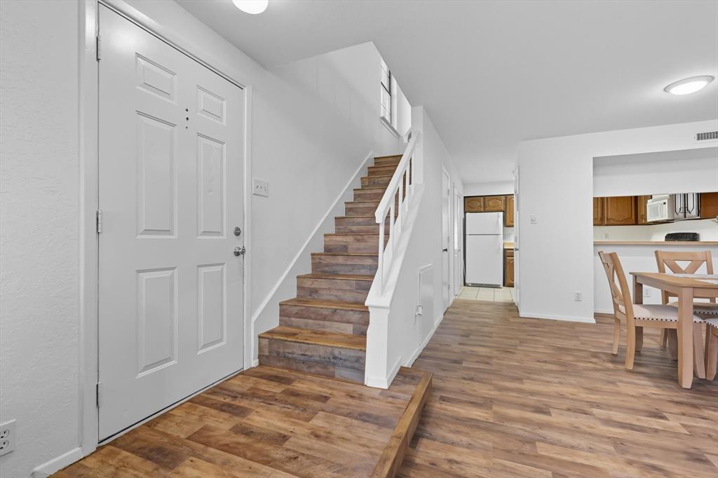 910 Turtle Cove, Unit 148 Irving, TX 75060 - Photo 2 of 33 a view of a hallway with wooden floor and entryway