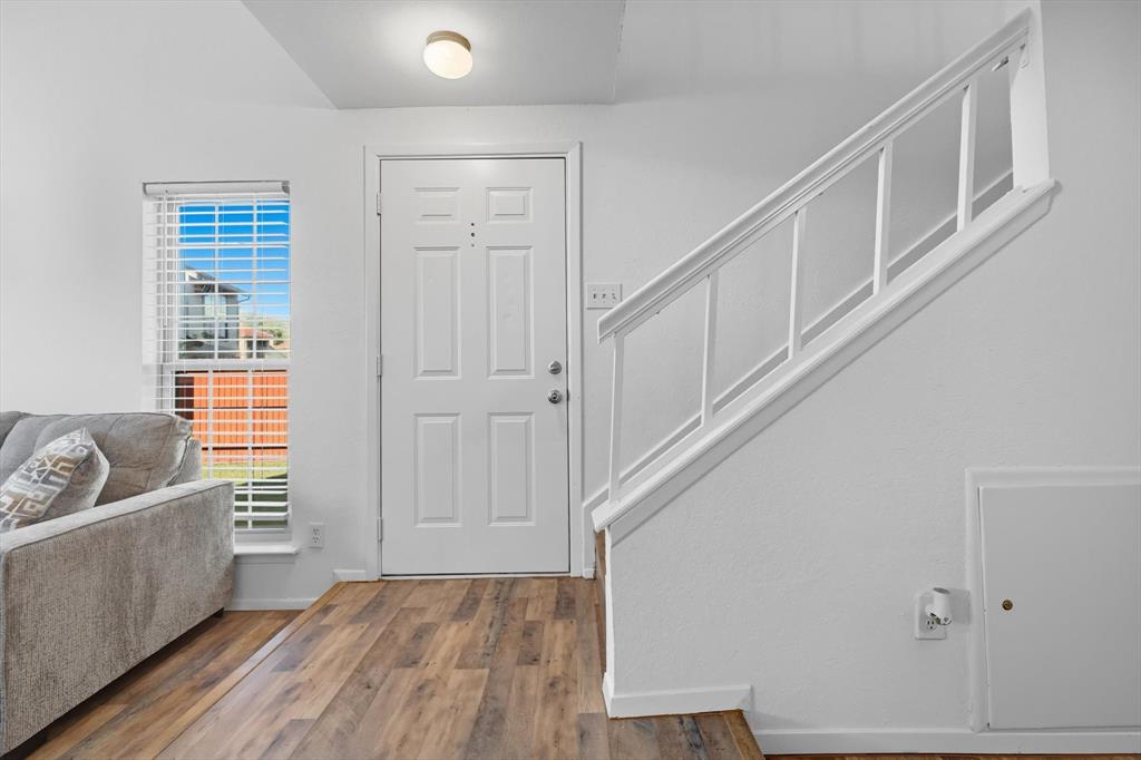 910 Turtle Cove, Unit 148 Irving, TX 75060 - Photo 3 of 33 a view of a livingroom with wooden floor and stairs