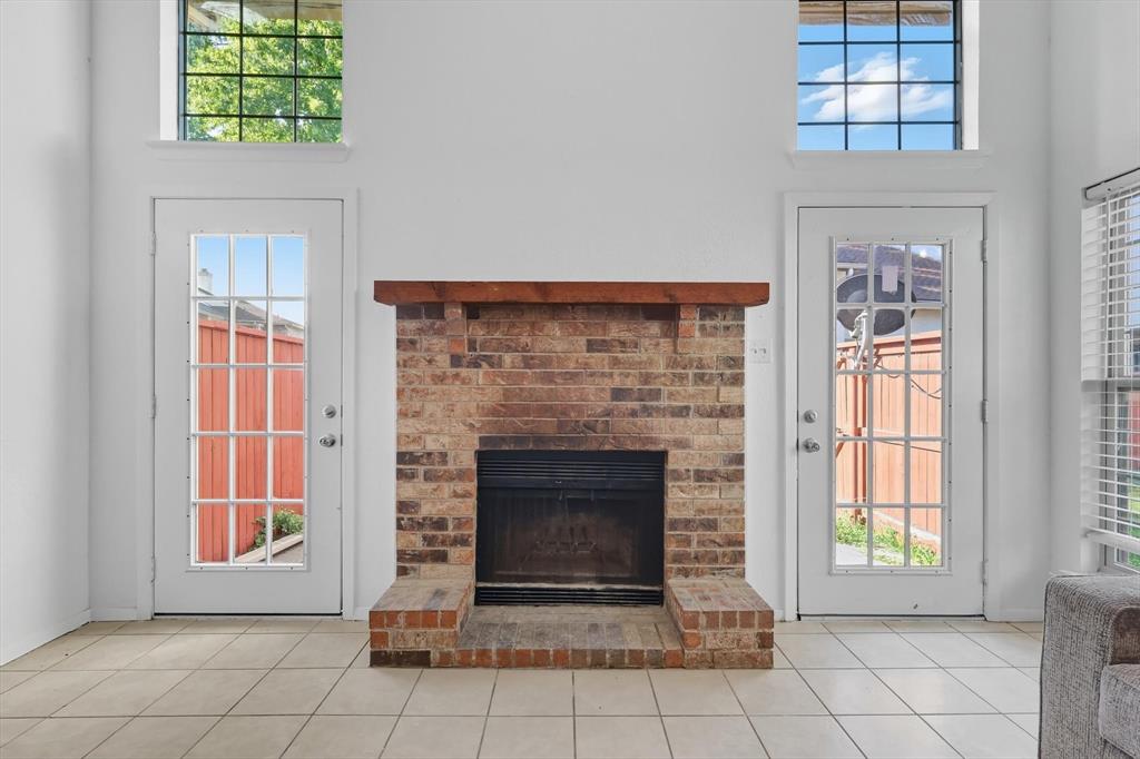 910 Turtle Cove, Unit 148 Irving, TX 75060 - Photo 7 of 33 an empty room with fireplace and windows
