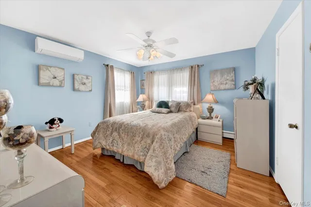 a spacious bedroom with a bed and a dresser