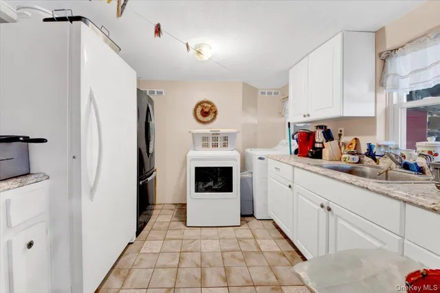 a kitchen with a cabinets and white appliances