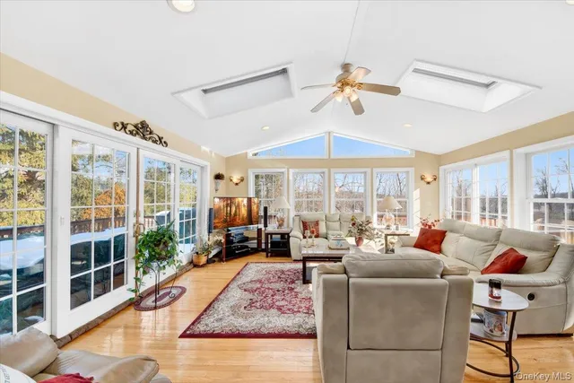 a living room with furniture fireplace and large windows