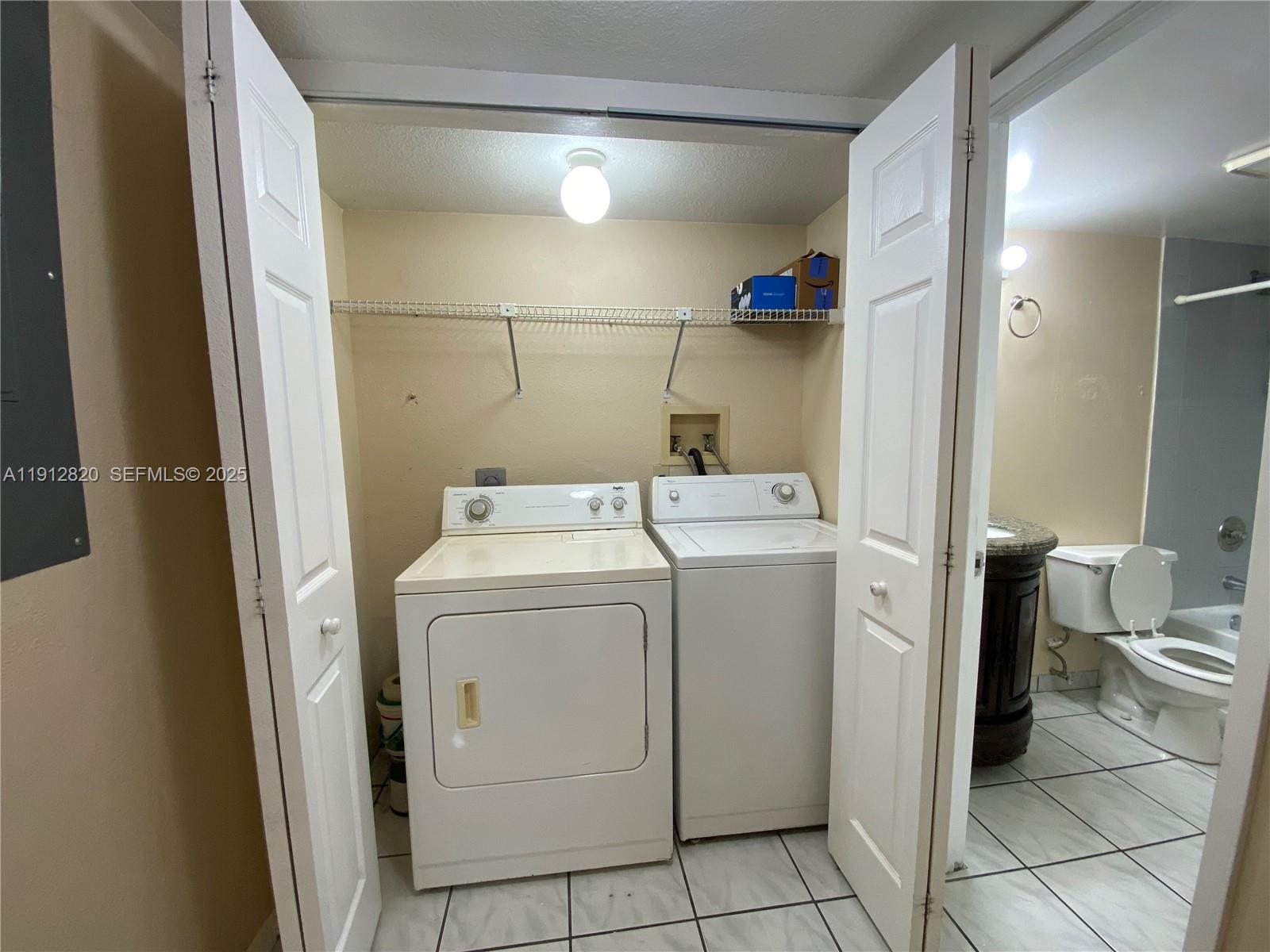 10370 Southwest 220th Street, Unit 221 Cutler Bay, FL 33190 - Photo 8 of 8 a utility room with dryer and washer
