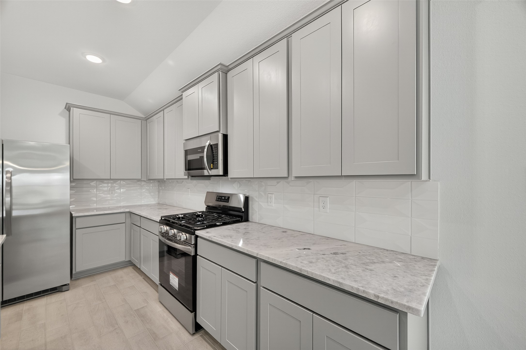 2111 Spring Hollow Drive Baytown, TX 77521 - Photo 11 of 42 a kitchen with stainless steel appliances granite countertop a sink stove and microwave