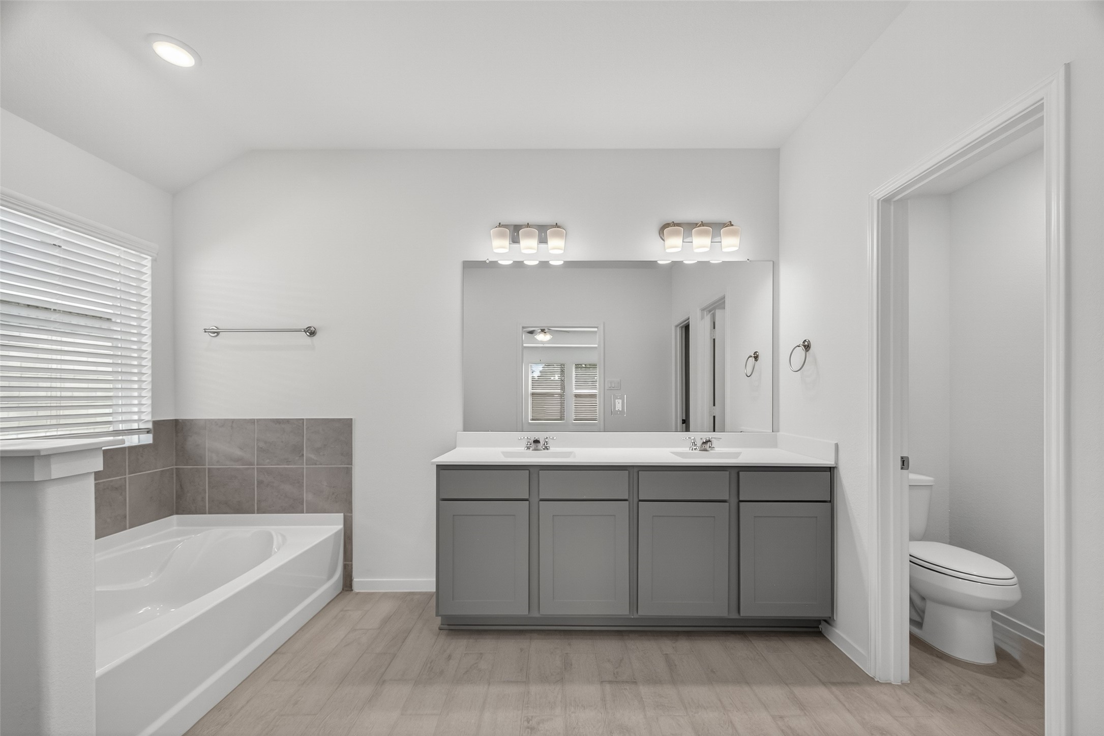 2111 Spring Hollow Drive Baytown, TX 77521 - Photo 34 of 42 a bathroom with a sink a toilet and bathtub