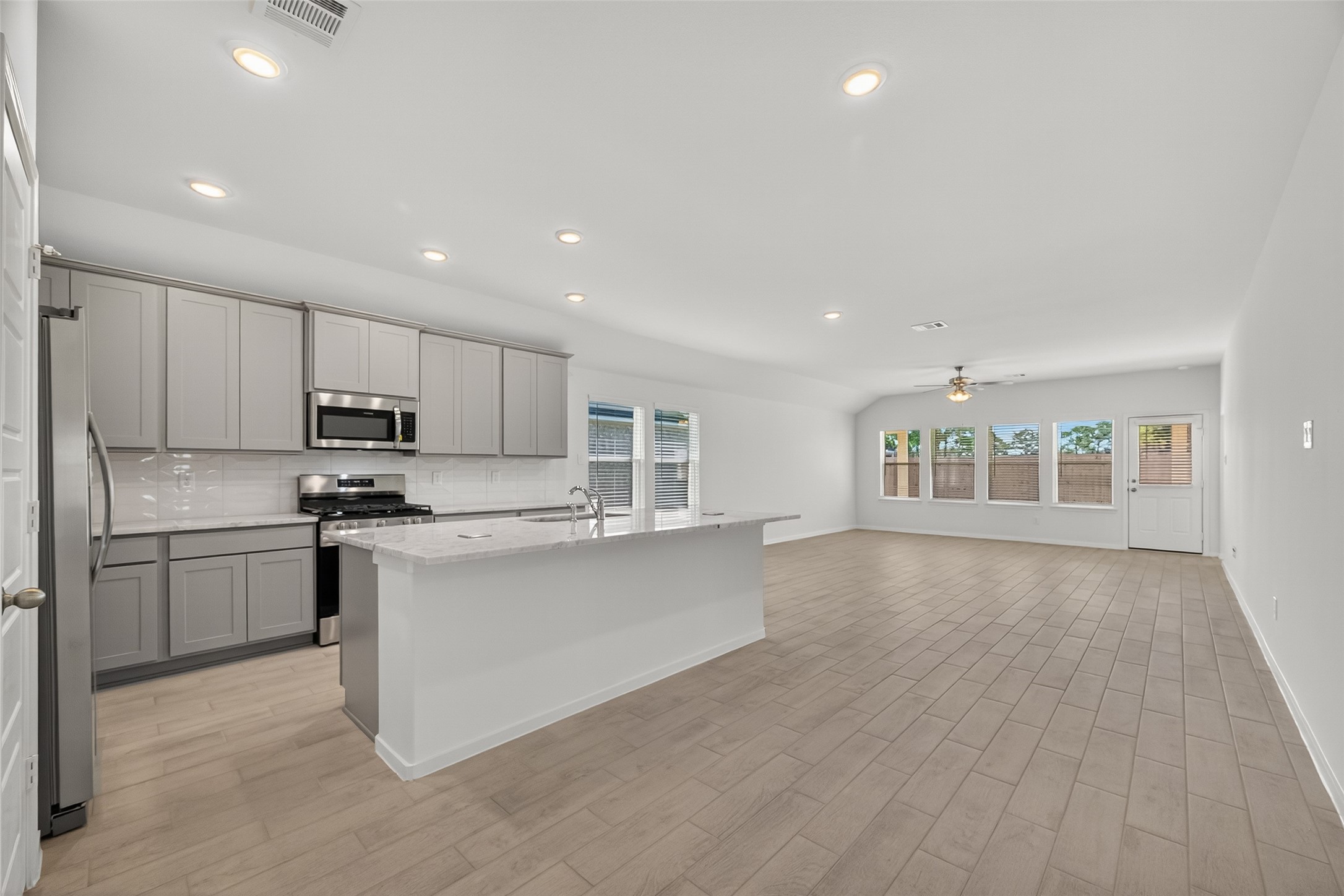 2111 Spring Hollow Drive Baytown, TX 77521 - Photo 6 of 42 a kitchen with stainless steel appliances granite countertop a refrigerator sink and stove