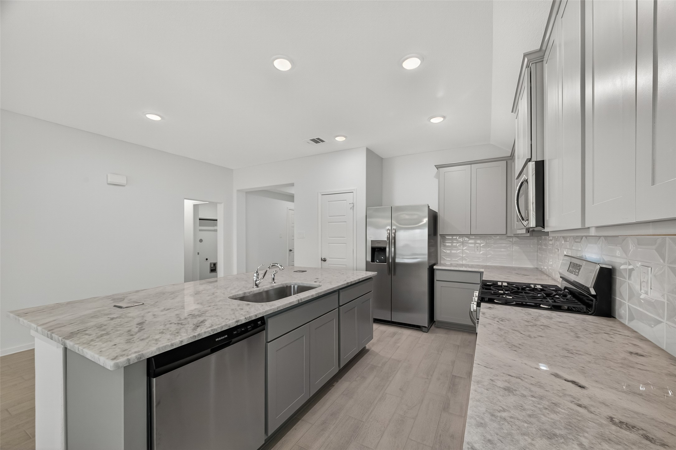 2111 Spring Hollow Drive Baytown, TX 77521 - Photo 10 of 42 a kitchen with a sink and refrigerator