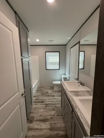 a bathroom with sink shower and mirror