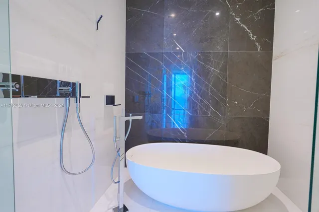 a bathroom with a sink a toilet and a shower