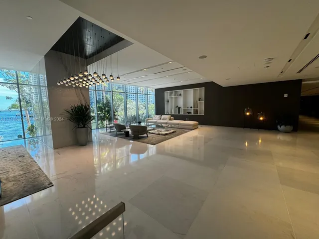 a lobby with furniture and floor to ceiling window