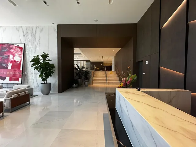 a lobby with furniture and a potted plant