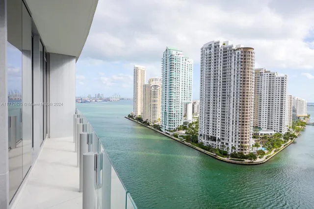 a kitchen with stainless steel appliances granite countertop a sink a oven and a large window