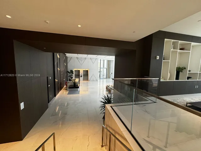 a lobby with furniture and a rug