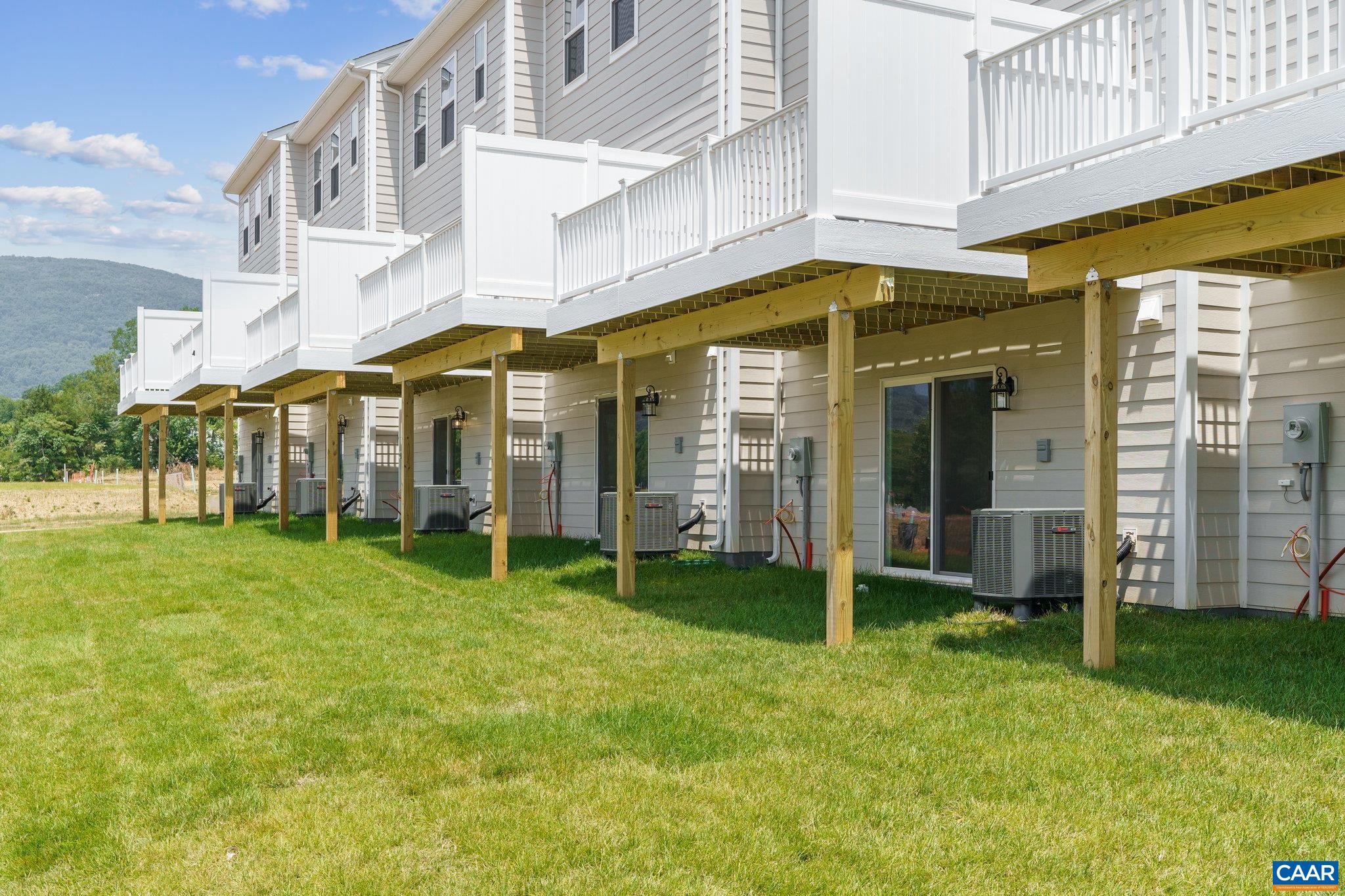 2992 Rambling Brk Lane, Unit LOT 124 Crozet, VA 22932 - Photo 28 of 44 a view of a large building with a big yard
