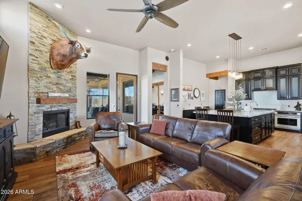 a kitchen with granite countertop kitchen island stainless steel appliances a sink stove and refrigerator