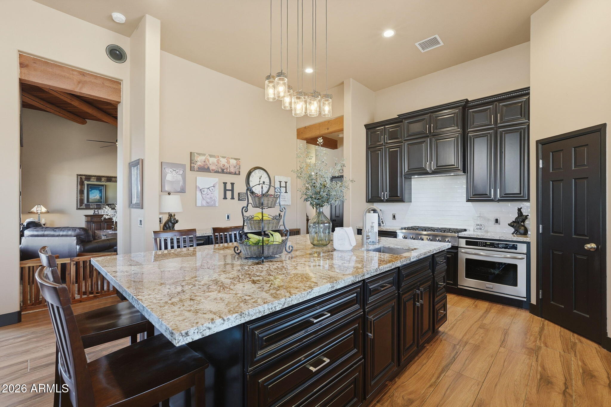 1114 East Carlise Road Phoenix, AZ 85086 - Photo 23 of 53 a kitchen with granite countertop kitchen island stainless steel appliances a sink stove and refrigerator