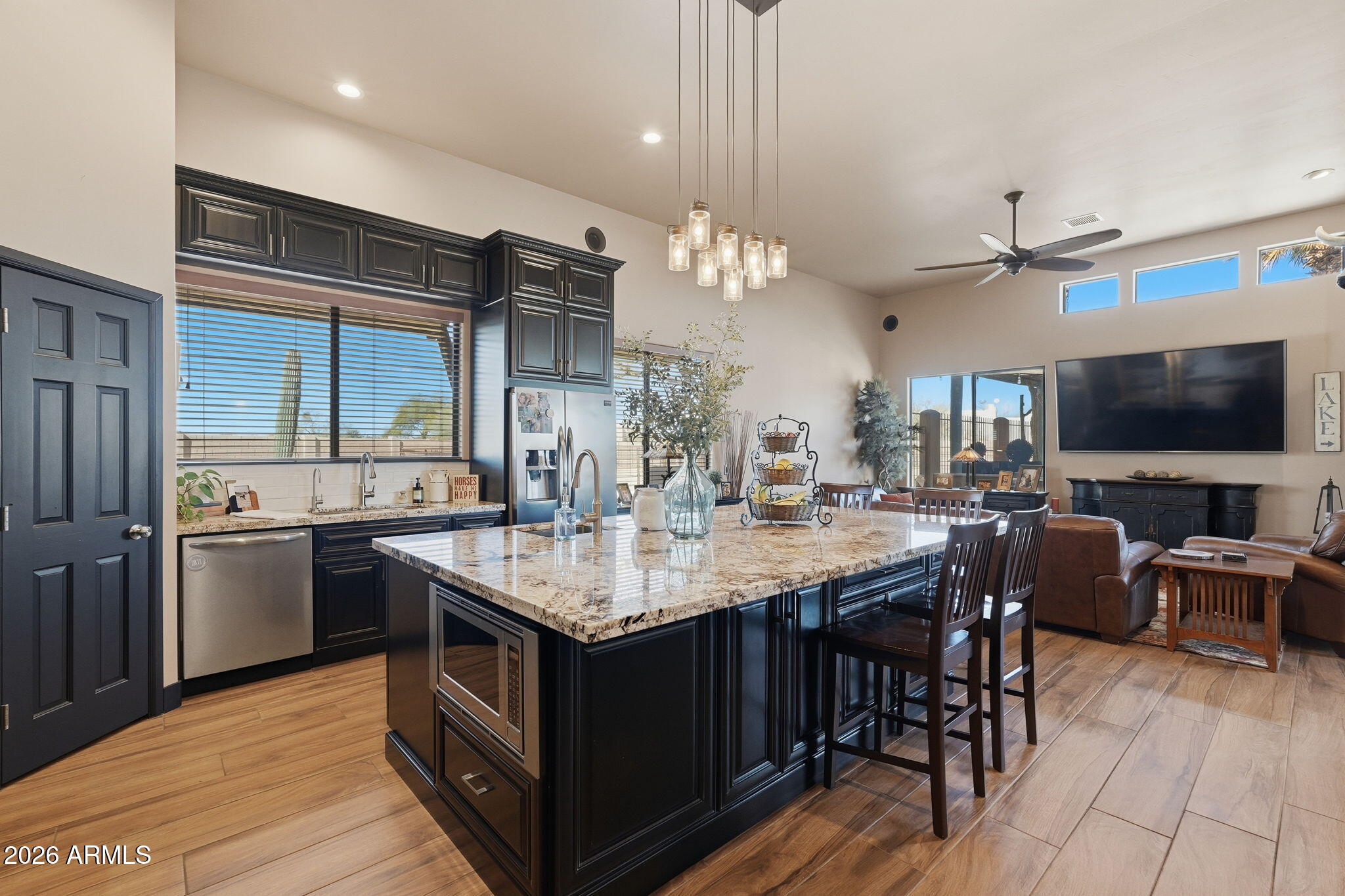 1114 East Carlise Road Phoenix, AZ 85086 - Photo 25 of 53 a kitchen with stainless steel appliances granite countertop a stove a sink dishwasher and a refrigerator with wooden floor