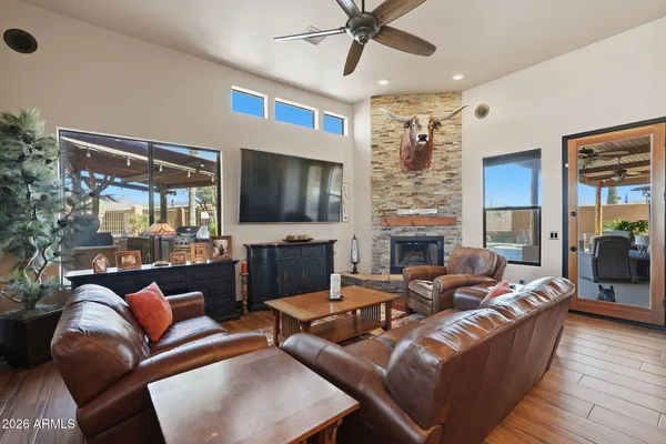 a living room with furniture a flat screen tv and a fireplace
