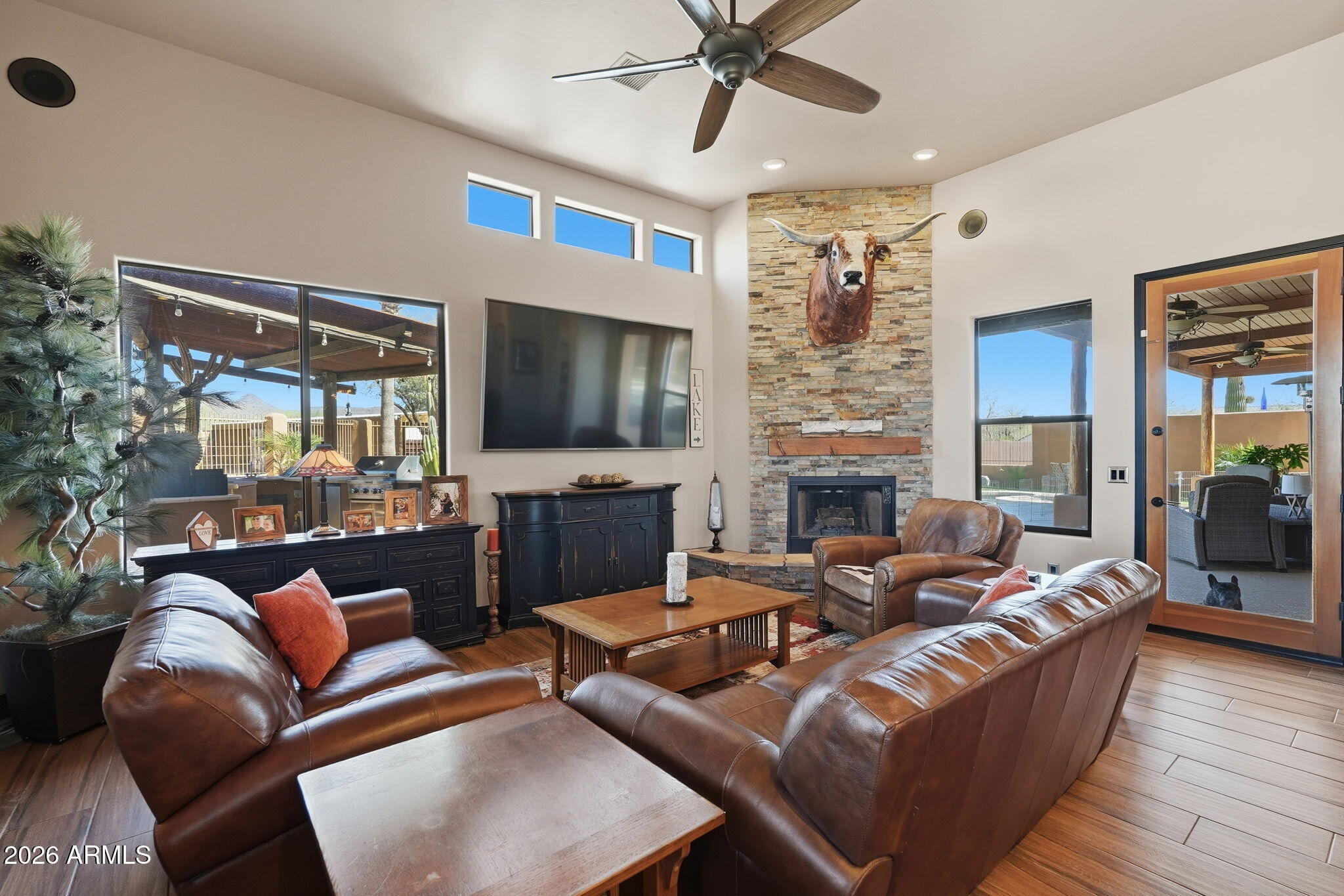 1114 East Carlise Road Phoenix, AZ 85086 - Photo 3 of 53 a living room with furniture a flat screen tv and a fireplace