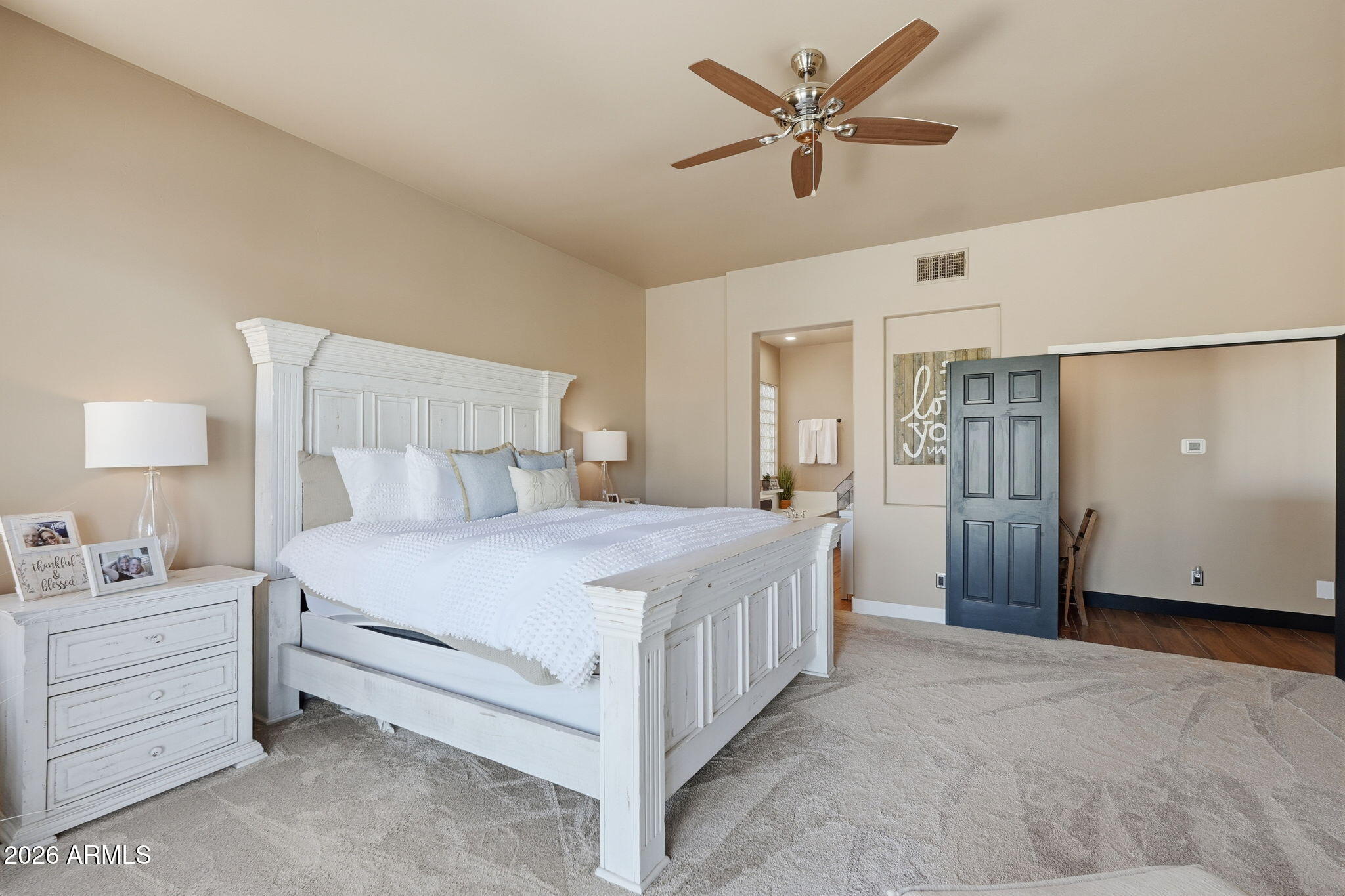 1114 East Carlise Road Phoenix, AZ 85086 - Photo 31 of 53 a bedroom with a bed and a chandelier fan