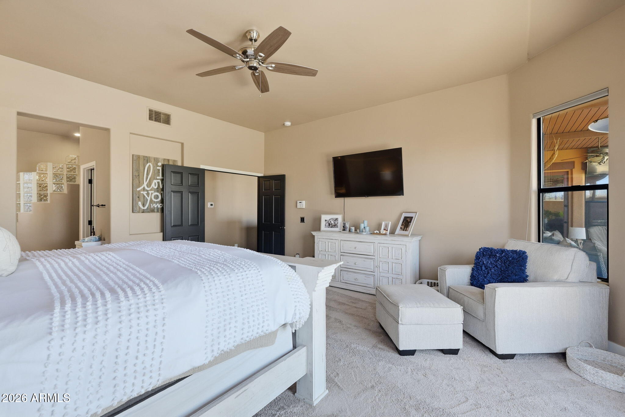 1114 East Carlise Road Phoenix, AZ 85086 - Photo 32 of 53 a bedroom with a bed a couch and a flat screen tv