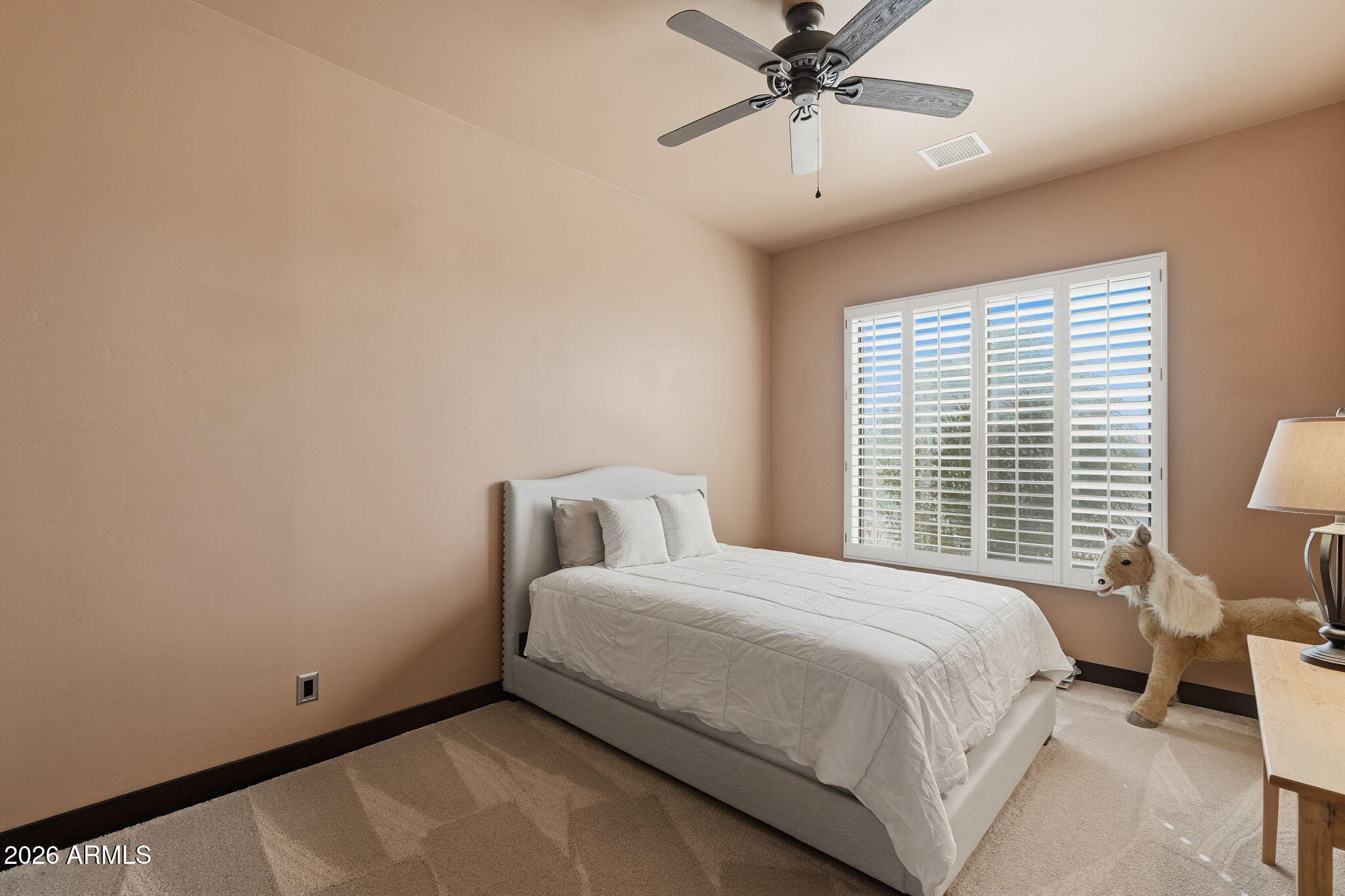 1114 East Carlise Road Phoenix, AZ 85086 - Photo 36 of 53 a bedroom with a bed and a chandelier
