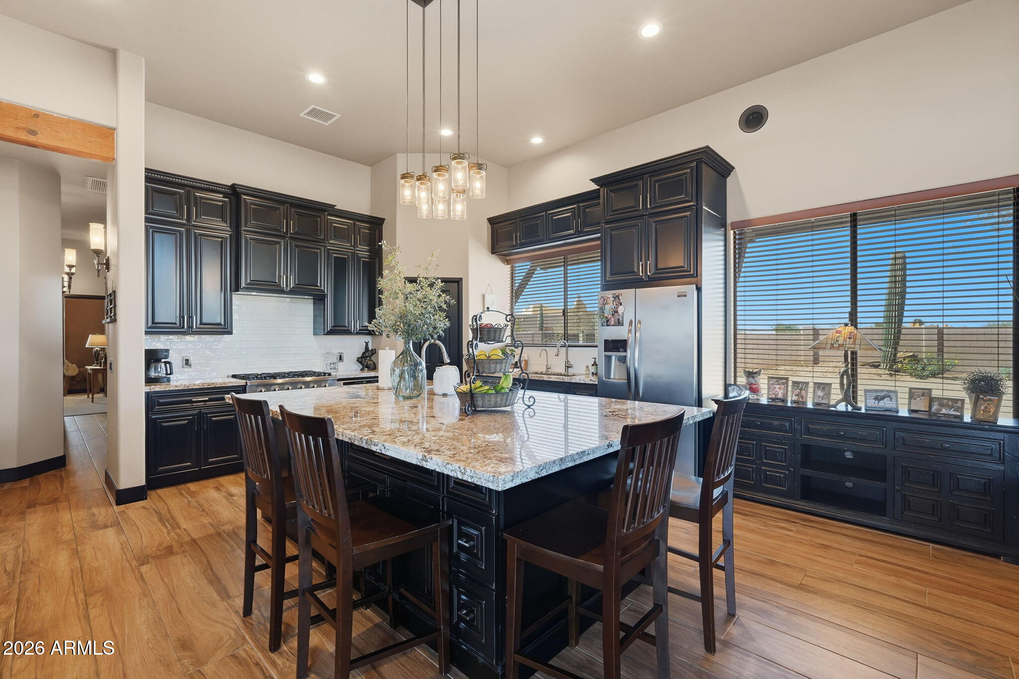1114 East Carlise Road Phoenix, AZ 85086 - Photo 4 of 53 a kitchen with a dining table chairs stainless steel appliances and cabinets