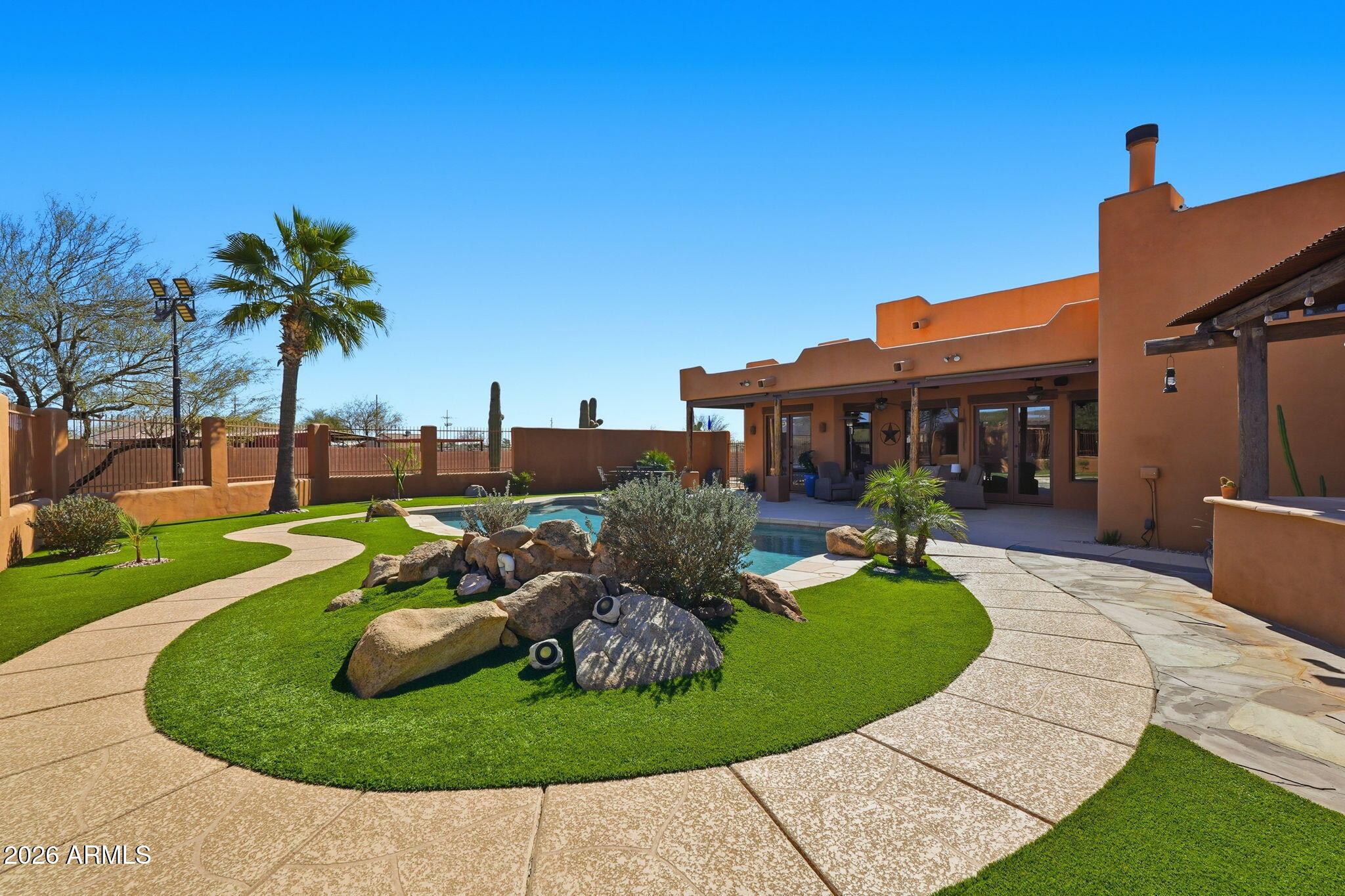 1114 East Carlise Road Phoenix, AZ 85086 - Photo 46 of 53 front view of a house with a yard potted plants and palm trees