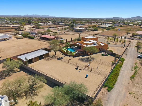 an aerial view of a house with a street