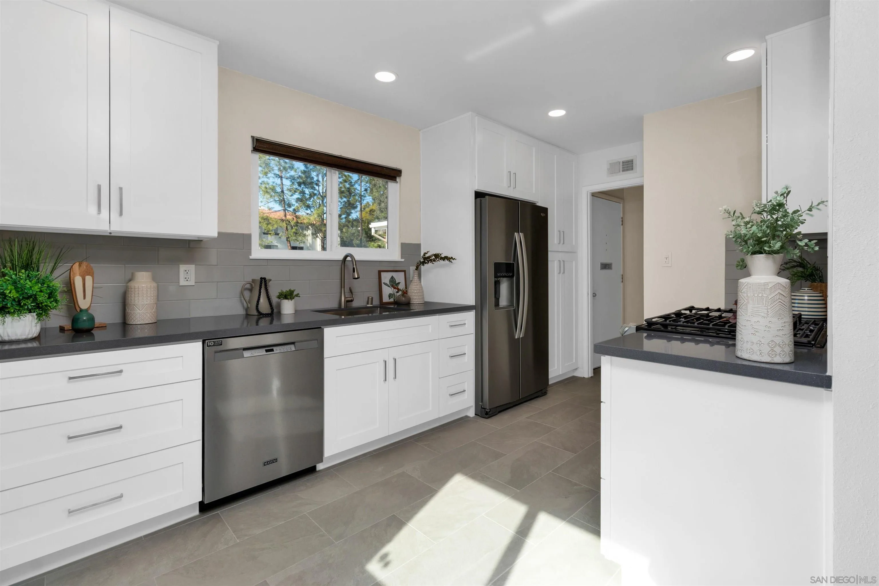5685 Jackson Drive La Mesa, CA 91942 - Photo 12 of 24 a kitchen with a refrigerator and cabinets
