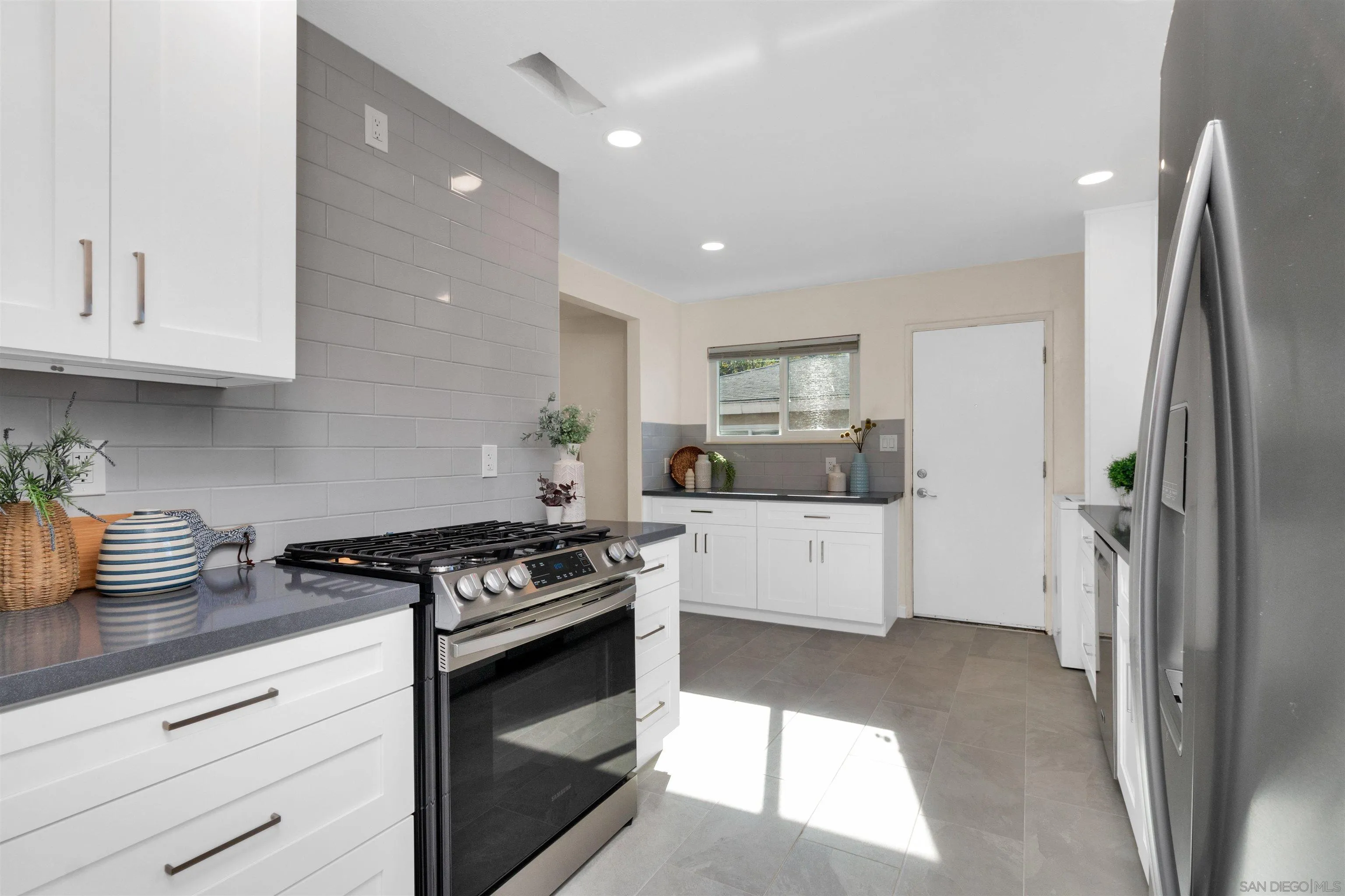 5685 Jackson Drive La Mesa, CA 91942 - Photo 13 of 24 a kitchen with stainless steel appliances granite countertop a stove a refrigerator and a sink