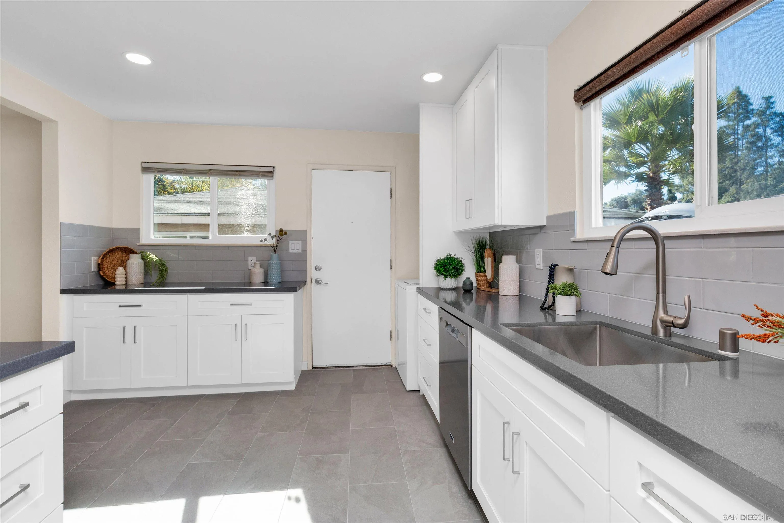 5685 Jackson Drive La Mesa, CA 91942 - Photo 14 of 24 a kitchen with a sink a counter top space cabinets and stainless steel appliances