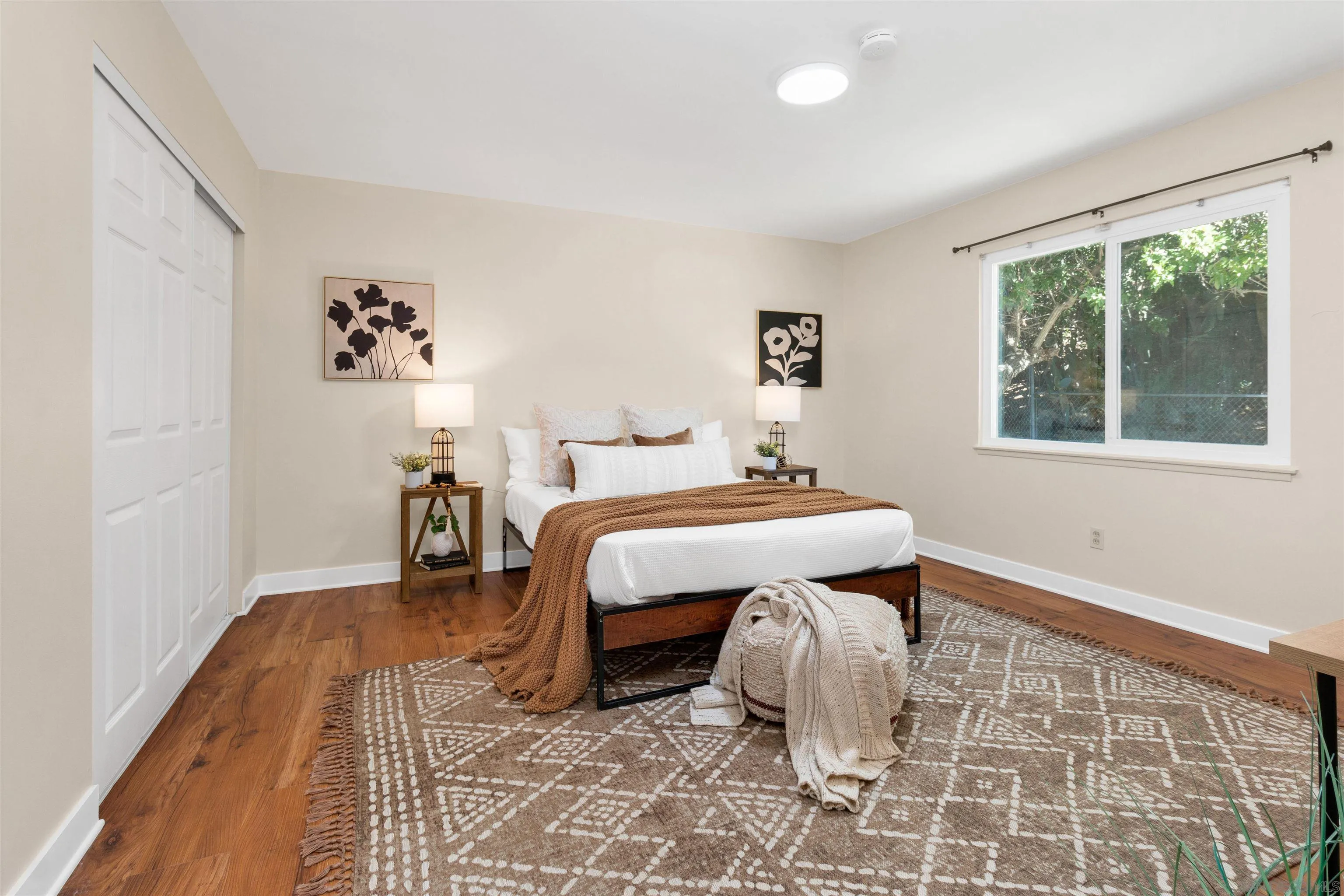 5685 Jackson Drive La Mesa, CA 91942 - Photo 16 of 24 a bedroom with a bed and wooden floor