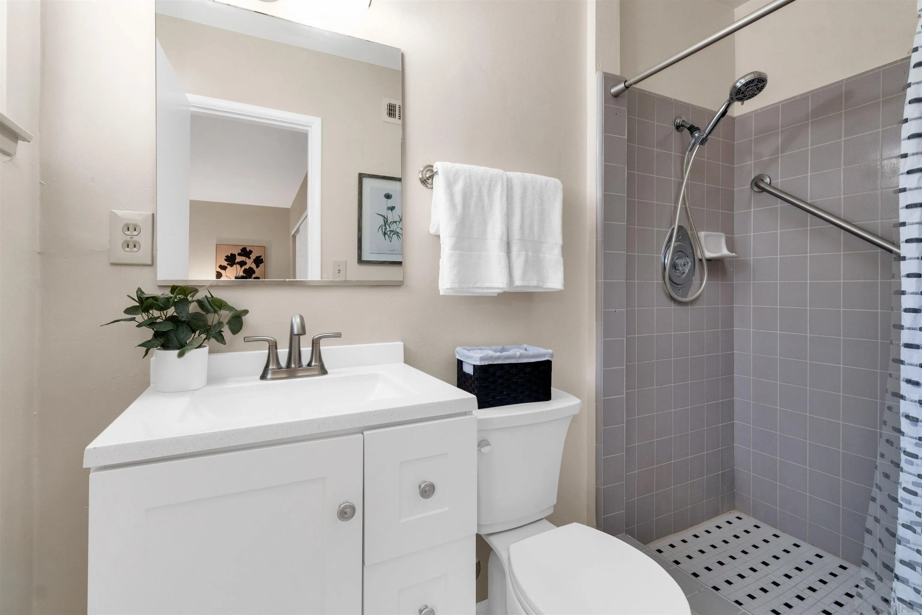 5685 Jackson Drive La Mesa, CA 91942 - Photo 18 of 24 a bathroom with a sink toilet a mirror and shower