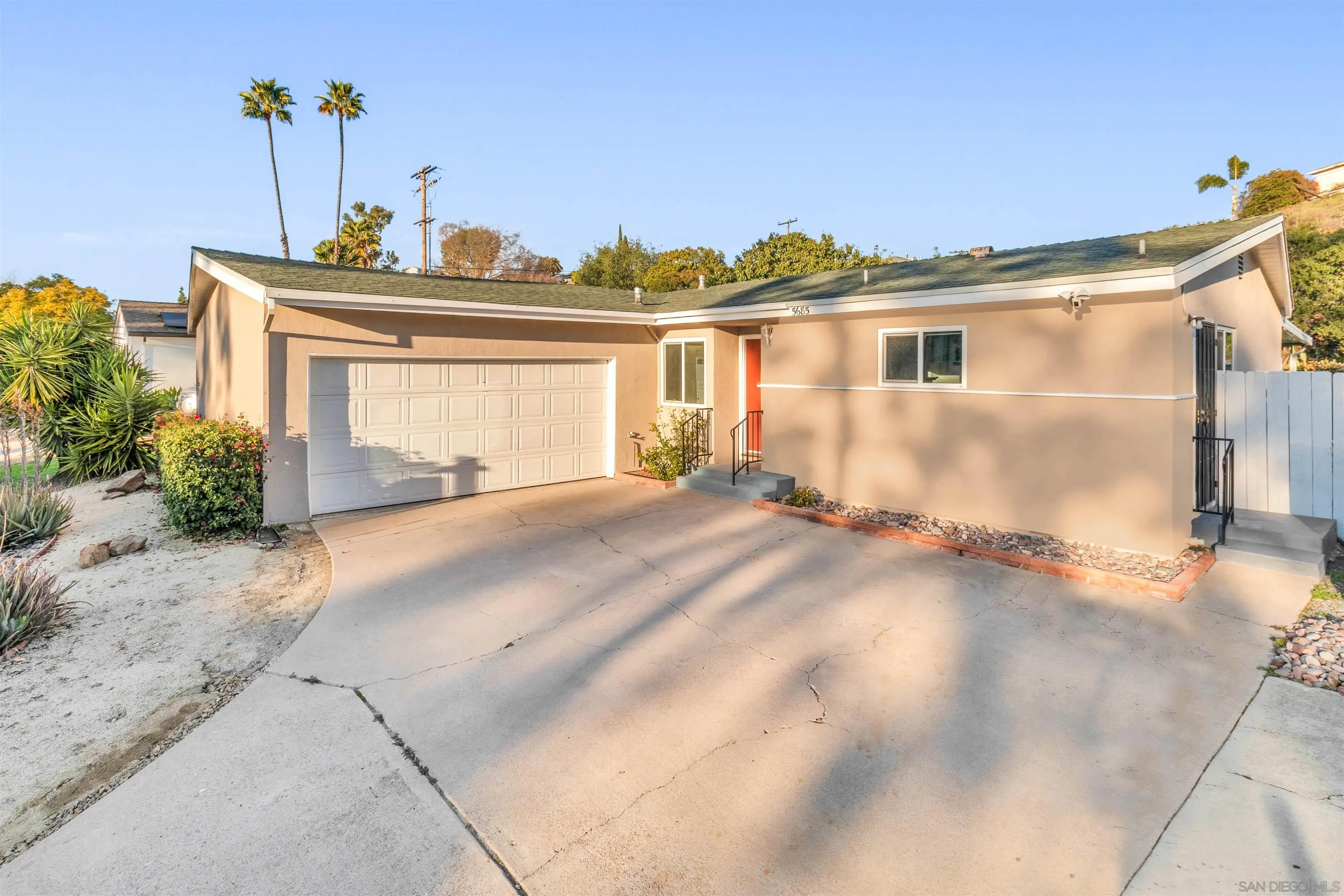 5685 Jackson Drive La Mesa, CA 91942 - Photo 2 of 24 a front view of a house with a yard and garage