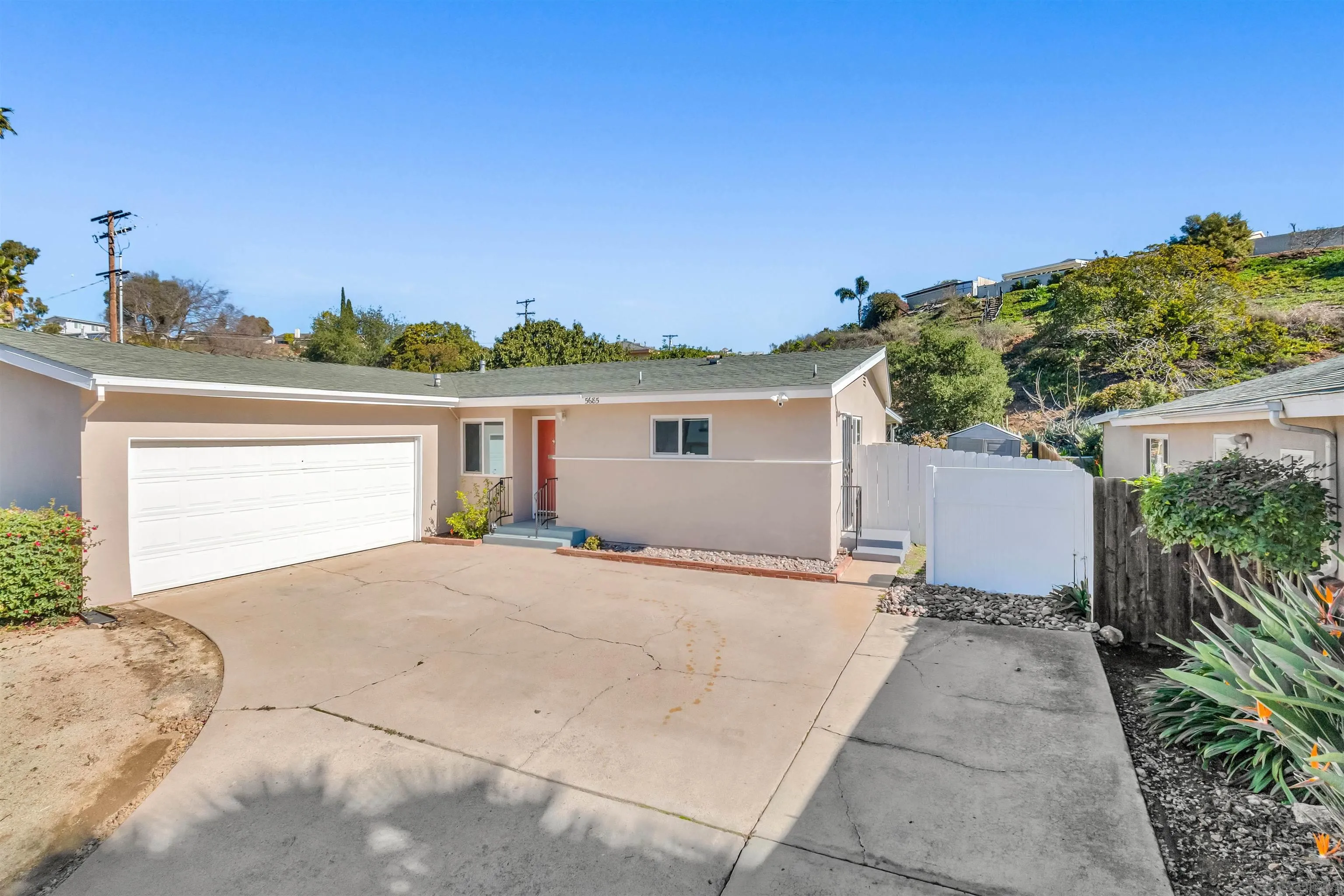 5685 Jackson Drive La Mesa, CA 91942 - Photo 3 of 24 a view of a house with a backyard and a garage
