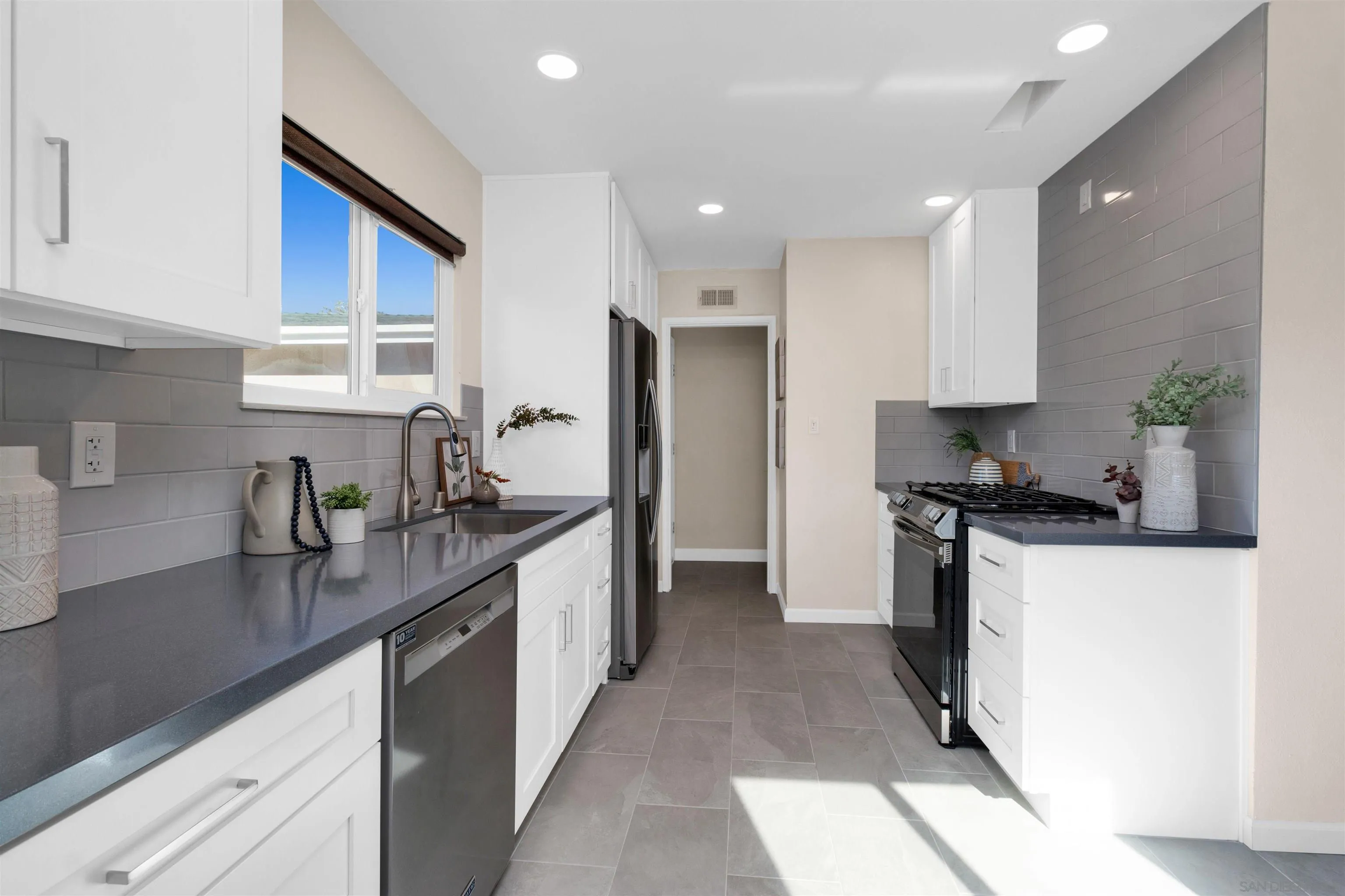 5685 Jackson Drive La Mesa, CA 91942 - Photo 10 of 24 a kitchen with a sink stove and refrigerator