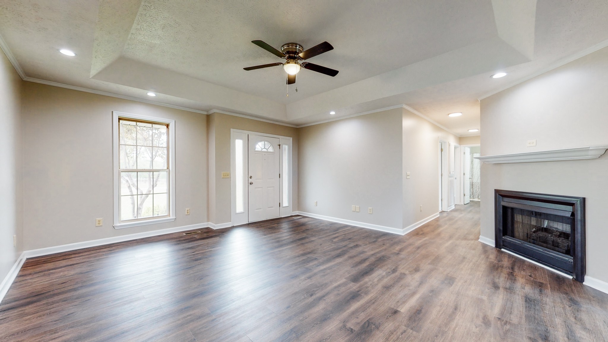 1883 Coles Ferry Pike Lebanon, TN 37087 - Photo 3 of 29 an empty room with wooden floor fireplace and windows