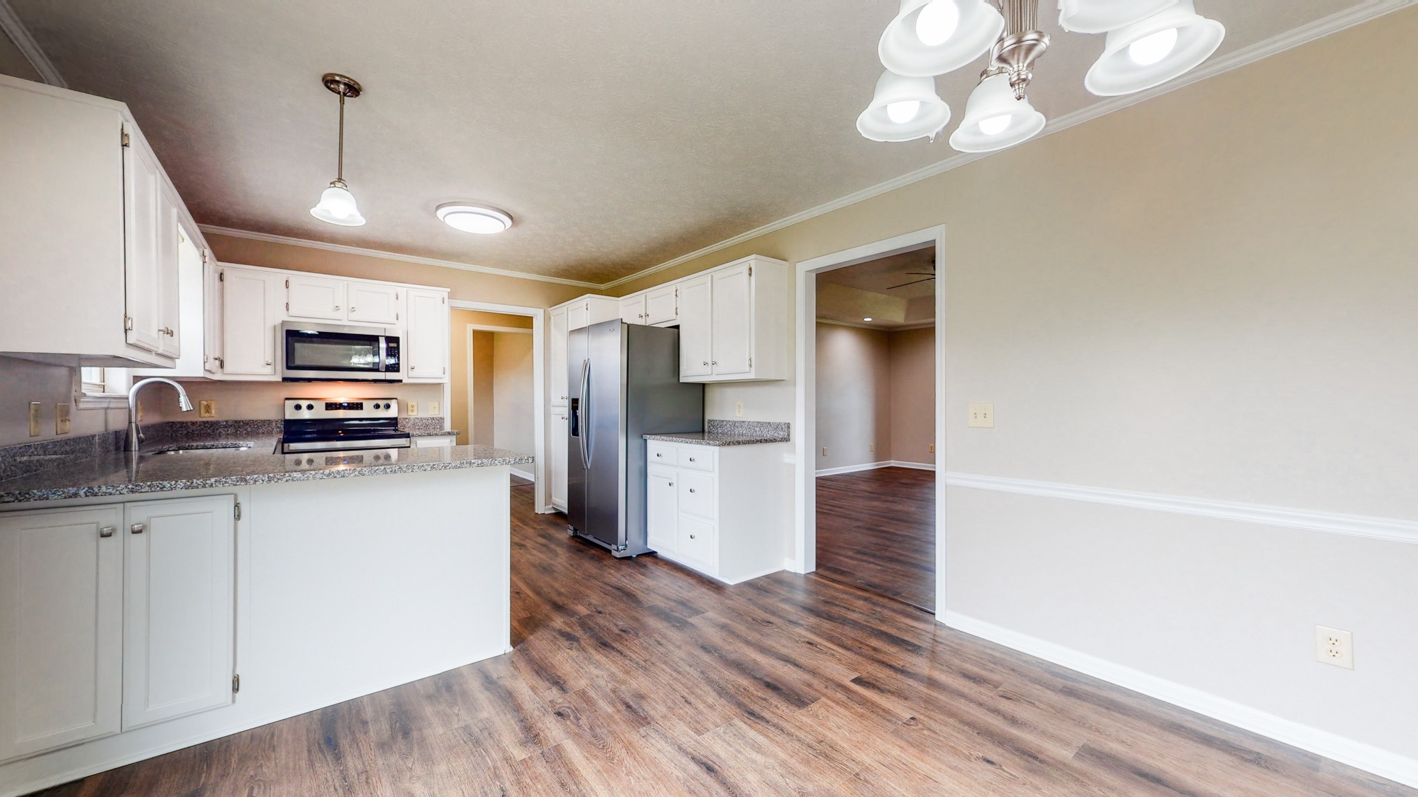 1883 Coles Ferry Pike Lebanon, TN 37087 - Photo 9 of 29 a kitchen with stainless steel appliances granite countertop a refrigerator a stove top oven a sink dishwasher and white cabinets with wooden floor