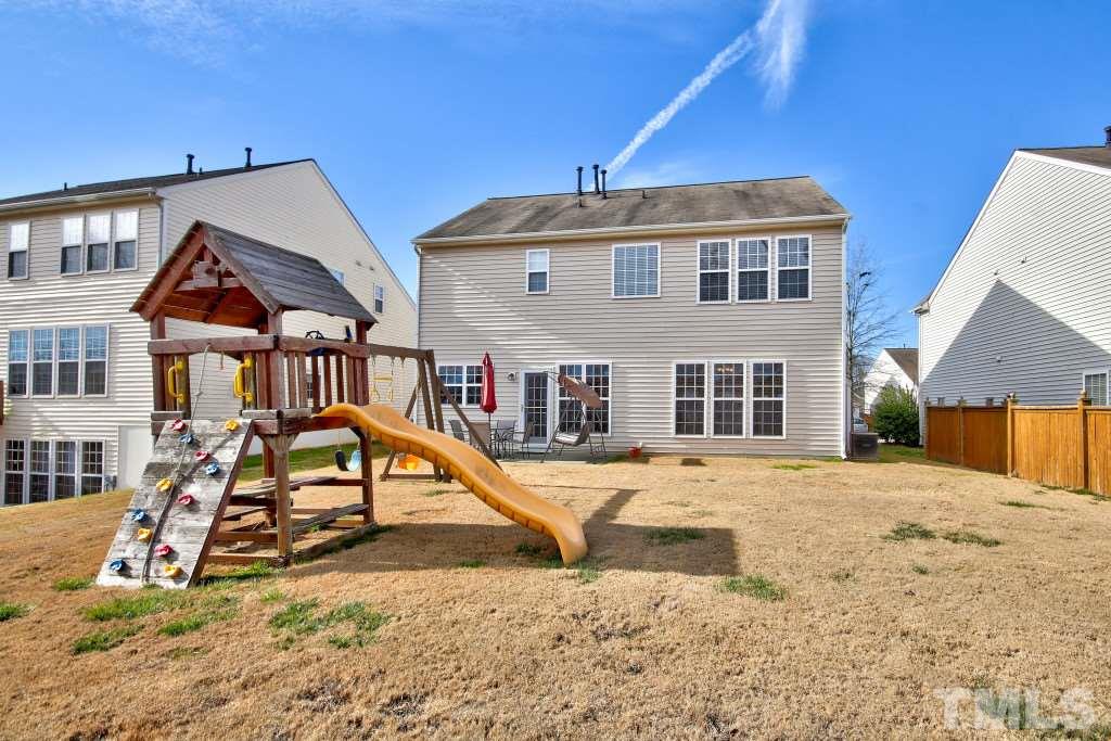 7754 San Gabriel Street Raleigh, NC 27613 - Photo 24 of 25 Great yard to play in! Grill out on the patio and let the kids play on the play set!