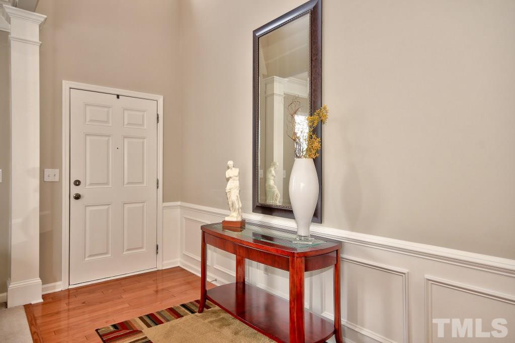 7754 San Gabriel Street Raleigh, NC 27613 - Photo 4 of 25 Step into a beautiful foyer featuring hard wood floors that opens into a wonderfully large family room with 10+ ft ceilings, a gas fireplace, picture molding and fresh paint!