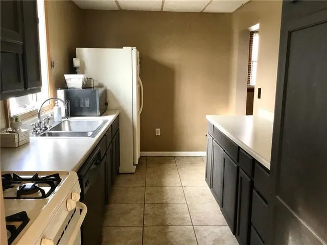 a kitchen with a refrigerator and a sink