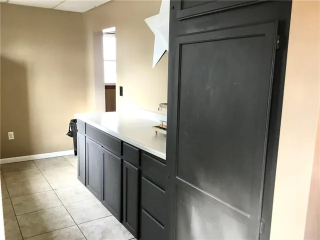 a kitchen with a sink cabinets and a window