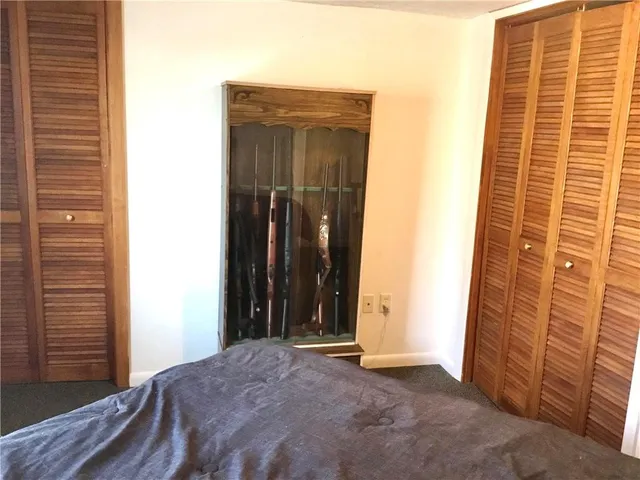 a bed sitting in a bedroom next to a window