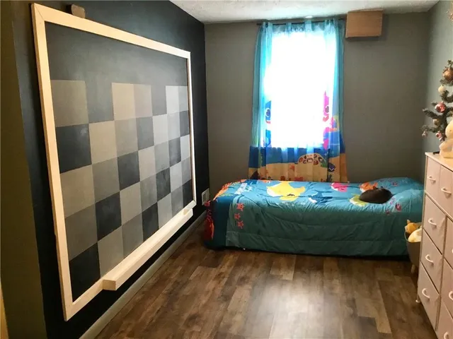 a bedroom with a bed and a dresser