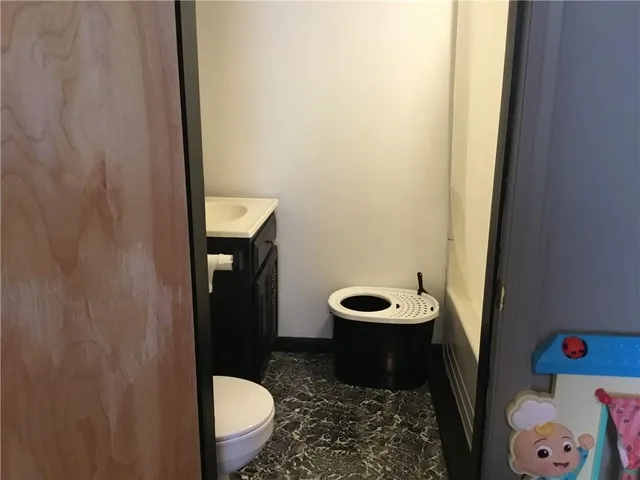 a room with a bed and dresser