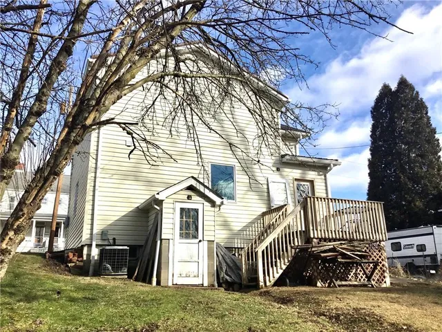 a view of yard covered with snow in front of house
