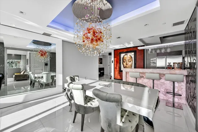 a kitchen with kitchen island a counter top space a sink stainless steel appliances and cabinets